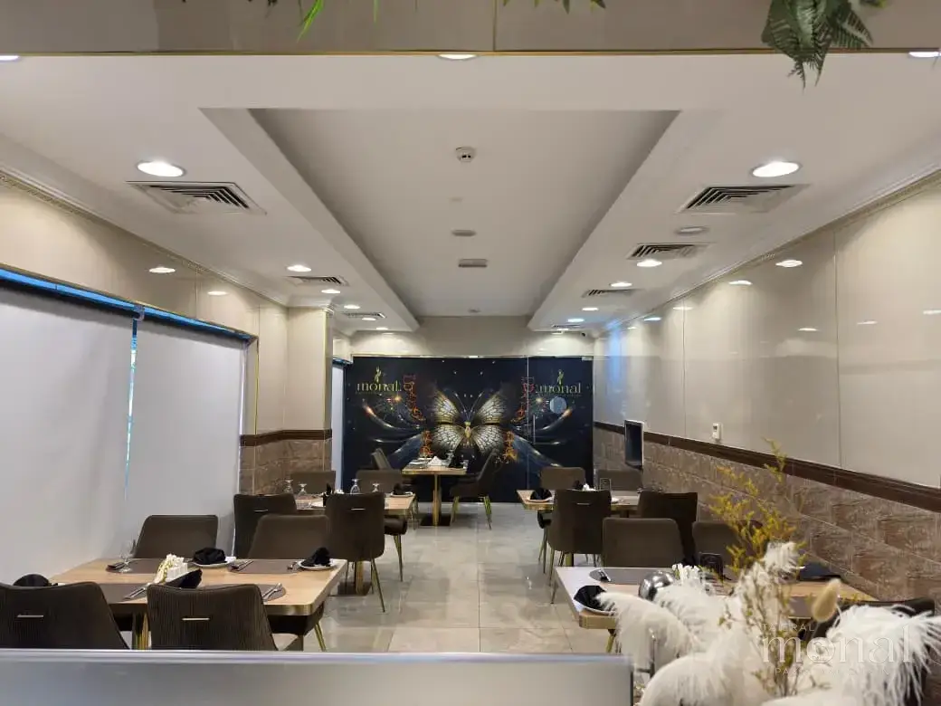 The main dining room at Taier Al Monal, with the Monal butterfly mural on the back wall